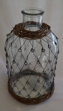 Glass bottle with 'fisherman' metal weave