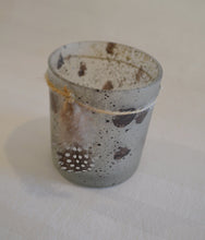 Speckled tea light candle with feather