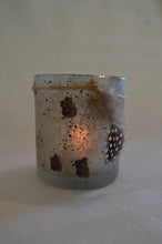 Speckled tea light candle with feather